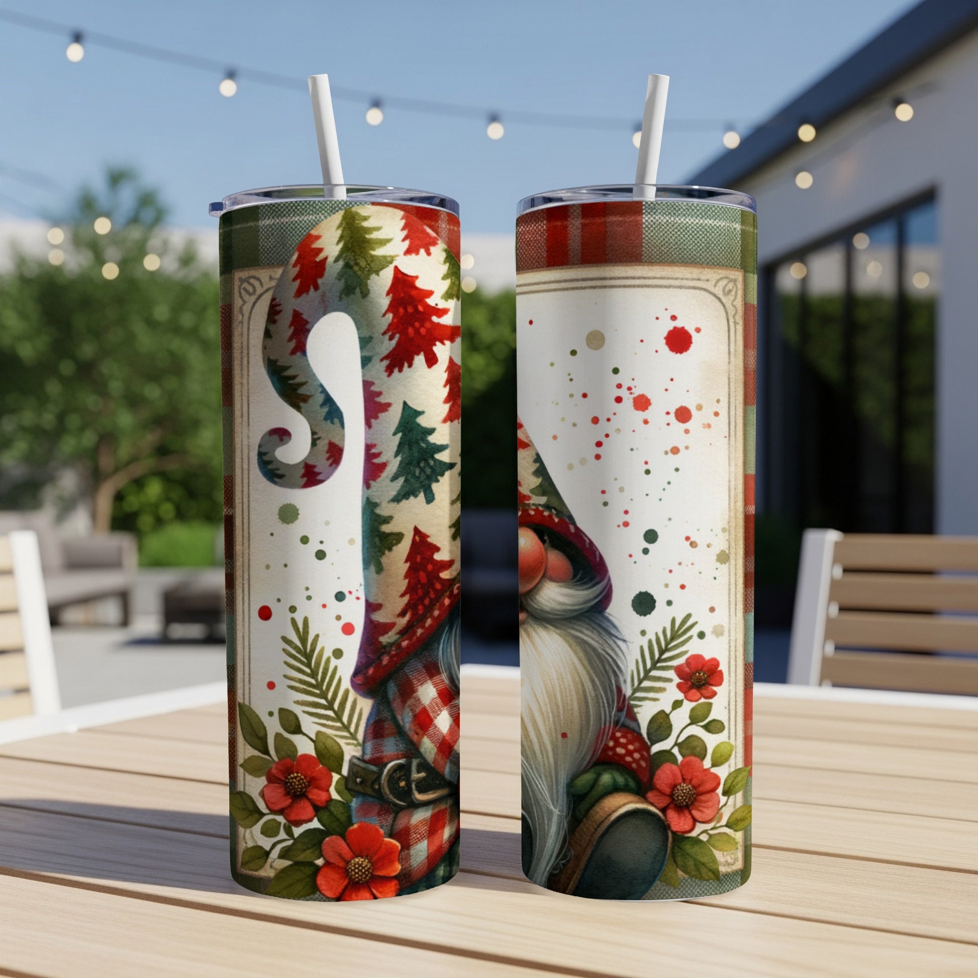 Two ceramic tumblers with a gnome and Christmas tree design sit on a wooden table.