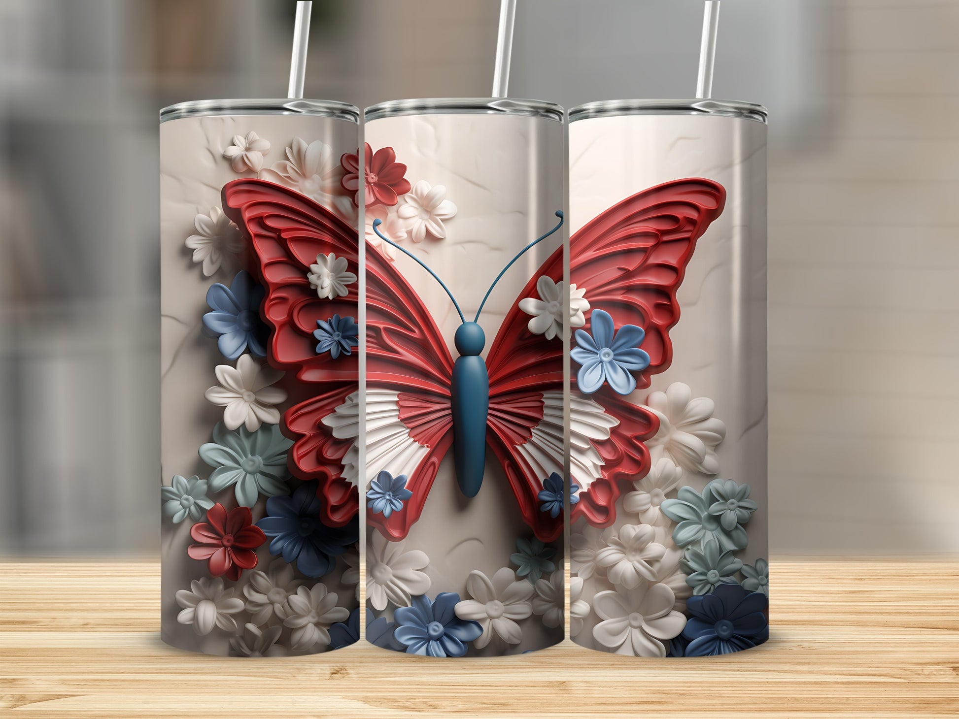 Three tumblers with red, white, and blue butterfly and floral designs.
