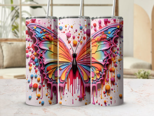 Colorful butterfly design on a white tumbler with pink drips.