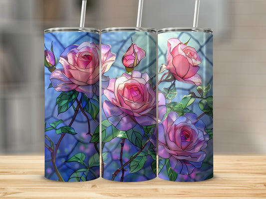 Three tumblers with stained glass rose design against a blurred background.