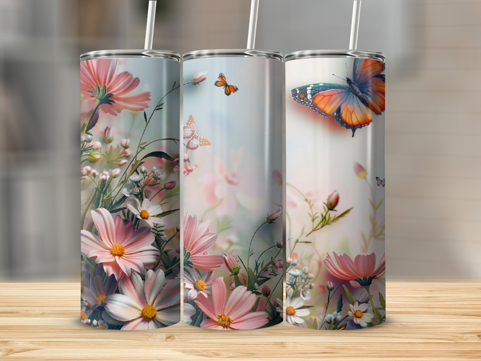 Three tumblers with floral and butterfly designs.