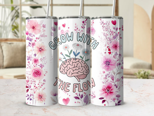 Pink floral tumbler with brain graphic and "Grow with the Flow" text.