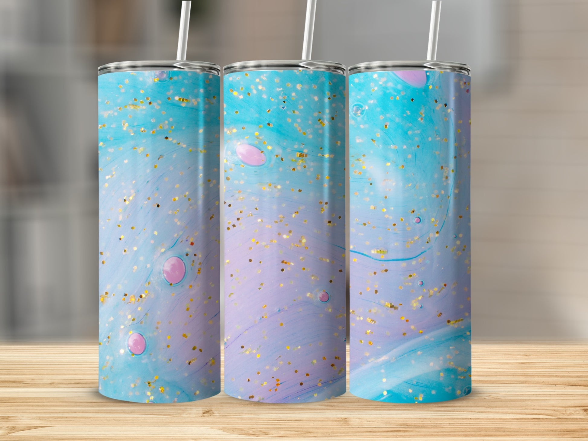 Three tumblers with blue, purple, and pink marble design with gold glitter.