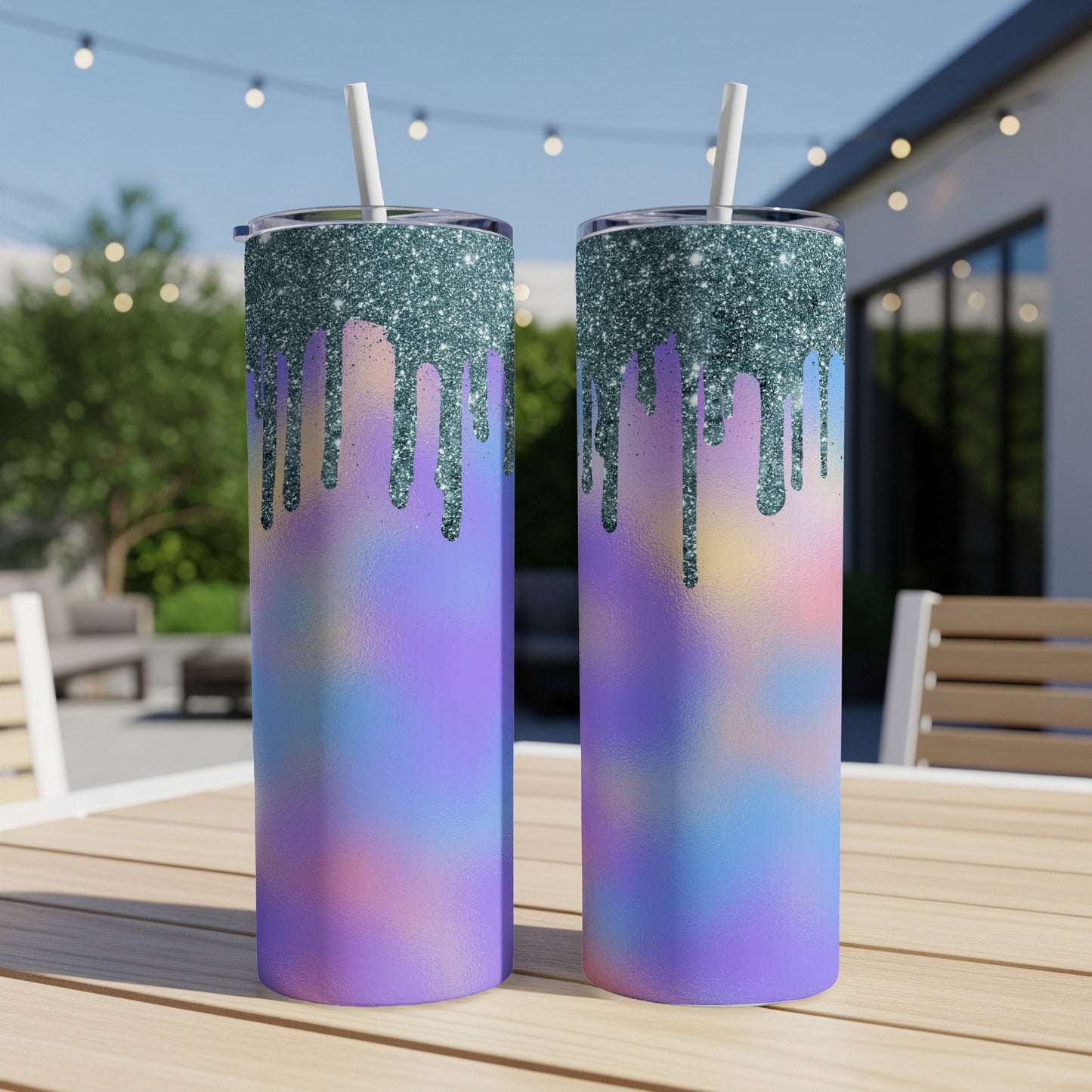 Two tumblers with glitter drip design and pastel ombre pattern on a table.