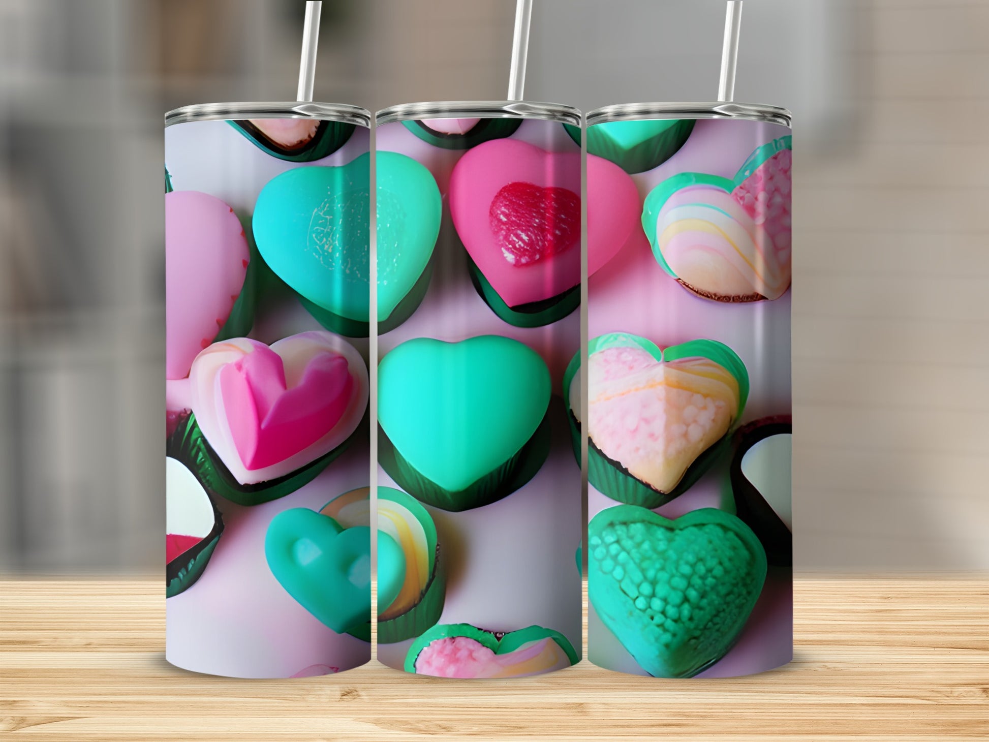 Three Valentine's Day heart-shaped candy tumblers arranged on a wooden surface.