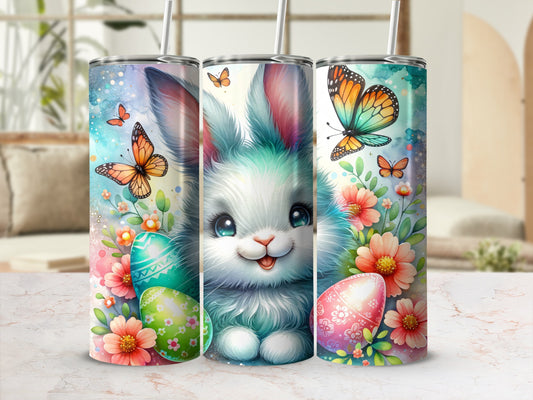 Easter bunny with colorful eggs and butterflies on a patterned tumbler.