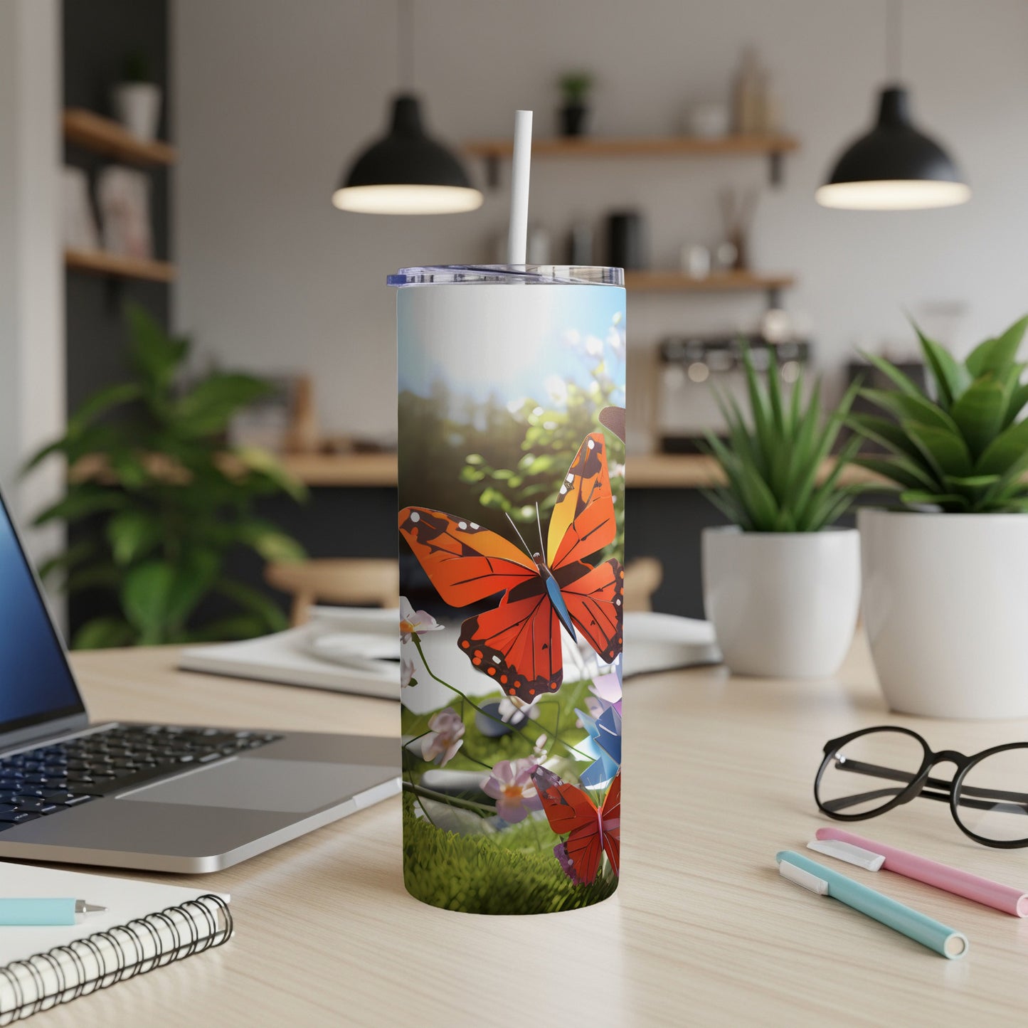 Orange butterfly on a tall tumbler with a grassy, floral background.
