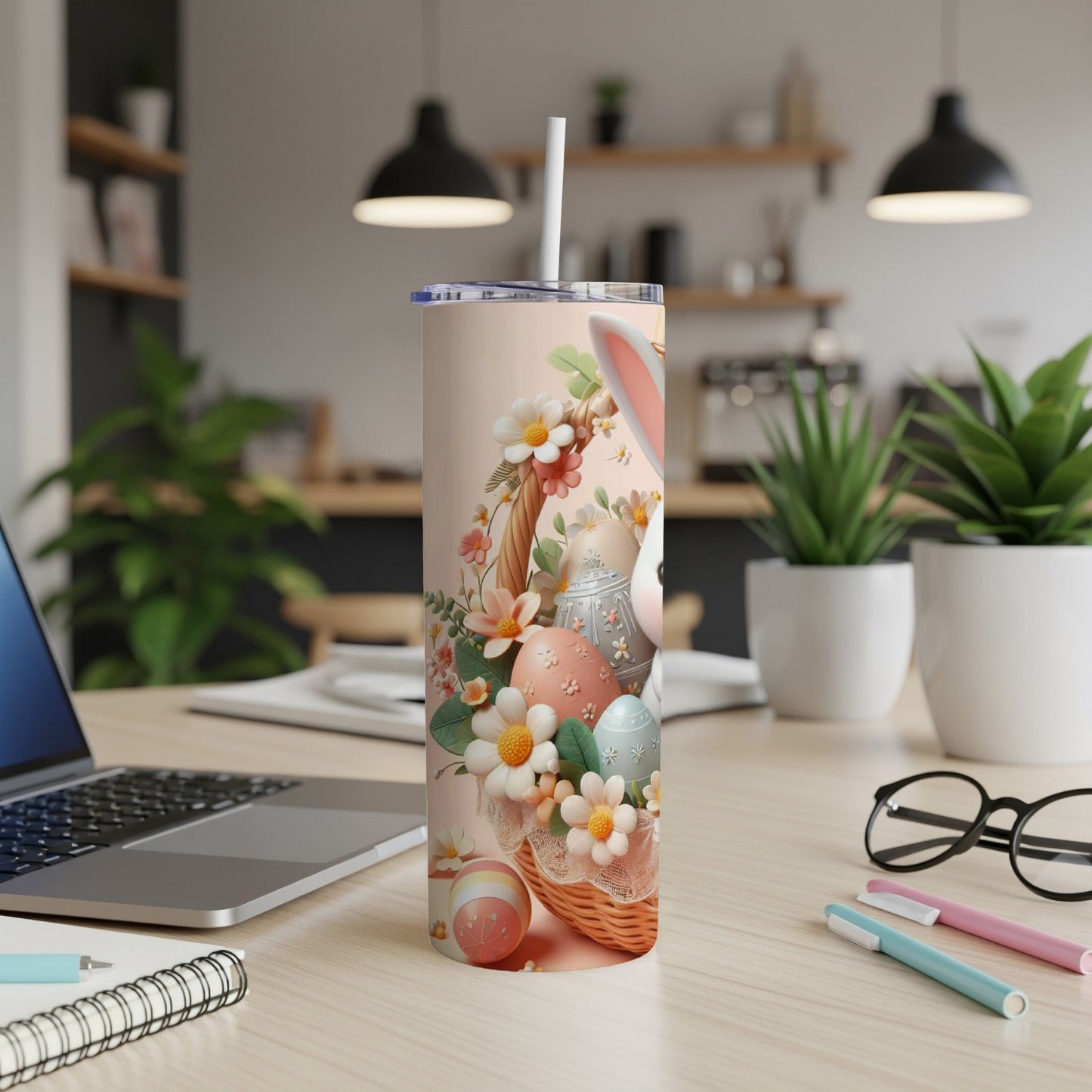 Easter bunny and colorful eggs on a light pink tumbler cup with straw.