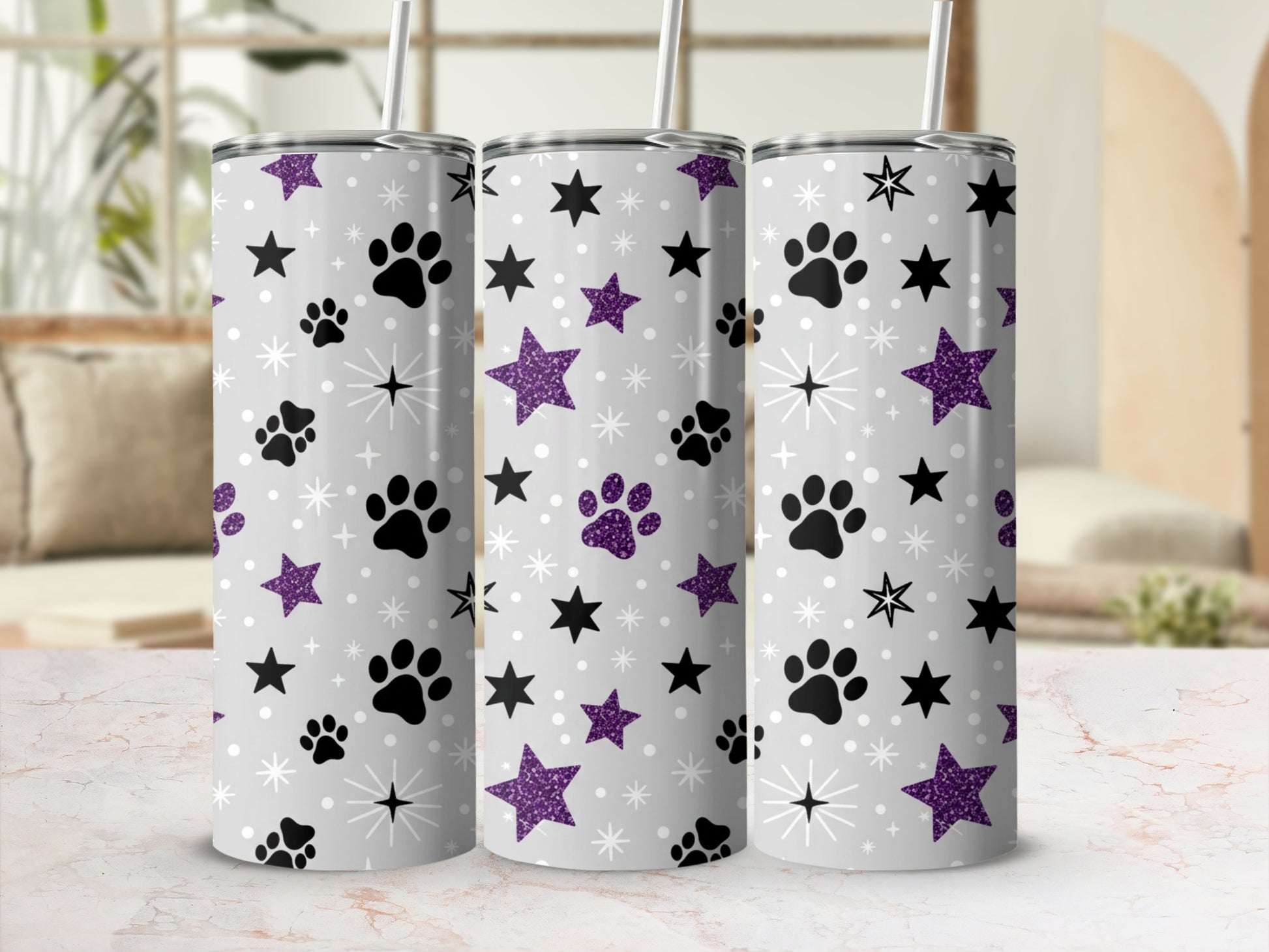 Gray tumbler with purple paw prints and glitter stars pattern.