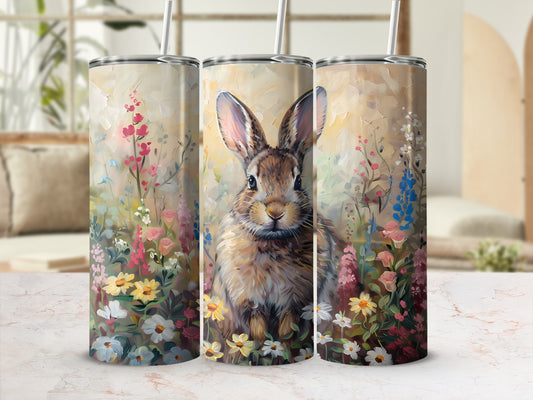 Bunny surrounded by colorful spring flowers on a cylindrical tumbler.