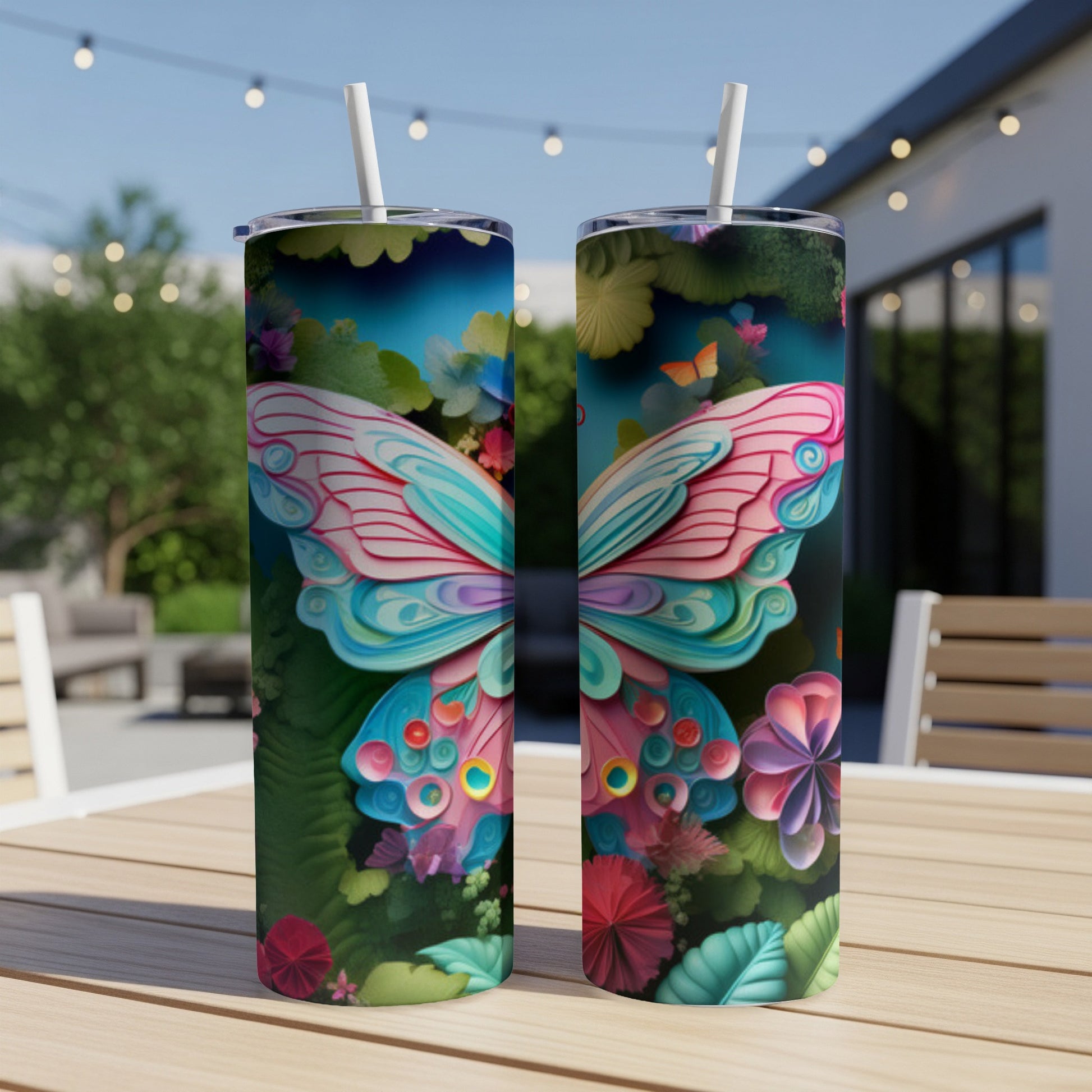 Two tumblers with colorful butterfly and floral designs sit on a table.