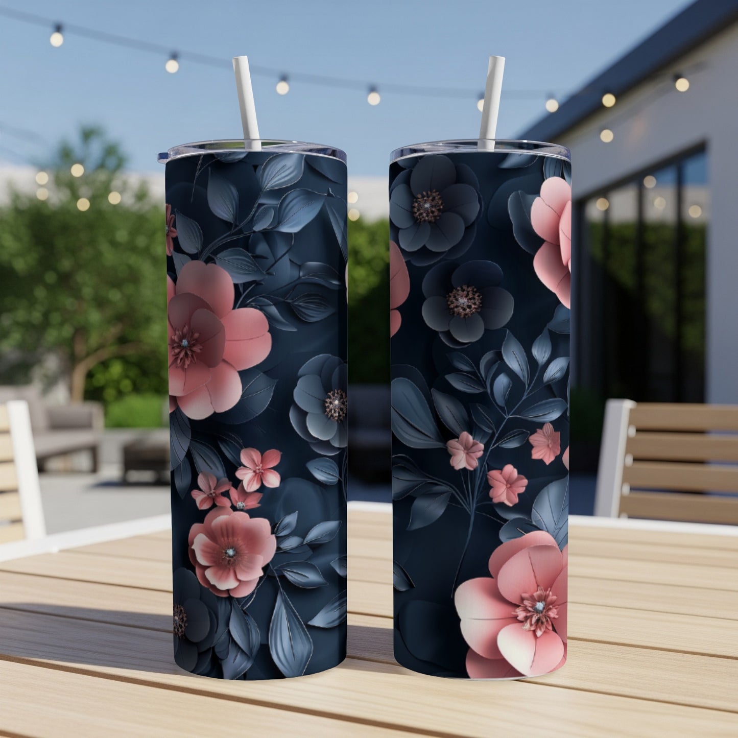 Two tumblers with a dark floral pattern and pink accents on a table.