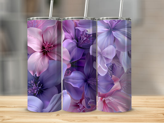 Three tumblers with purple and pink floral designs on a wooden surface.