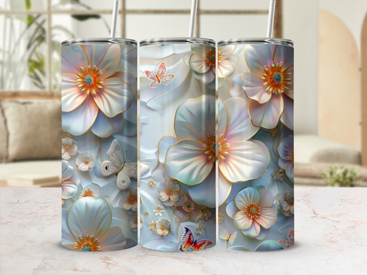 Floral pattern with butterflies on three tumblers with straws.