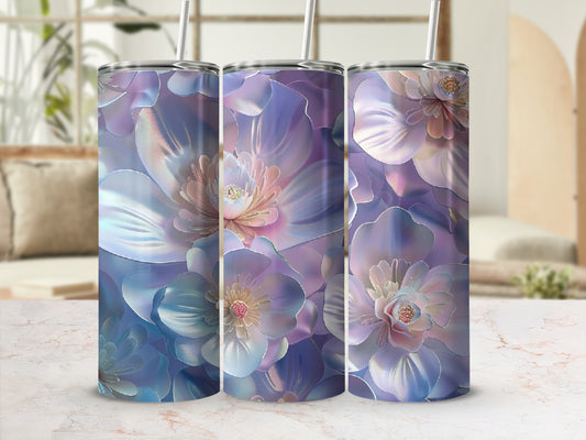 Three iridescent floral tumblers with straw on a marbled countertop.