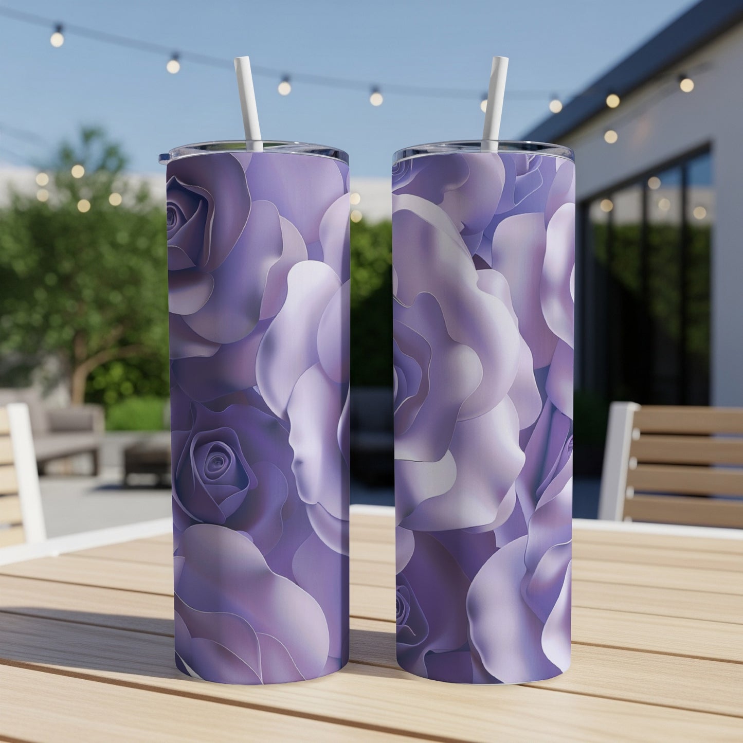 Two tumblers with a purple rose floral pattern sit on a wooden table outdoors.