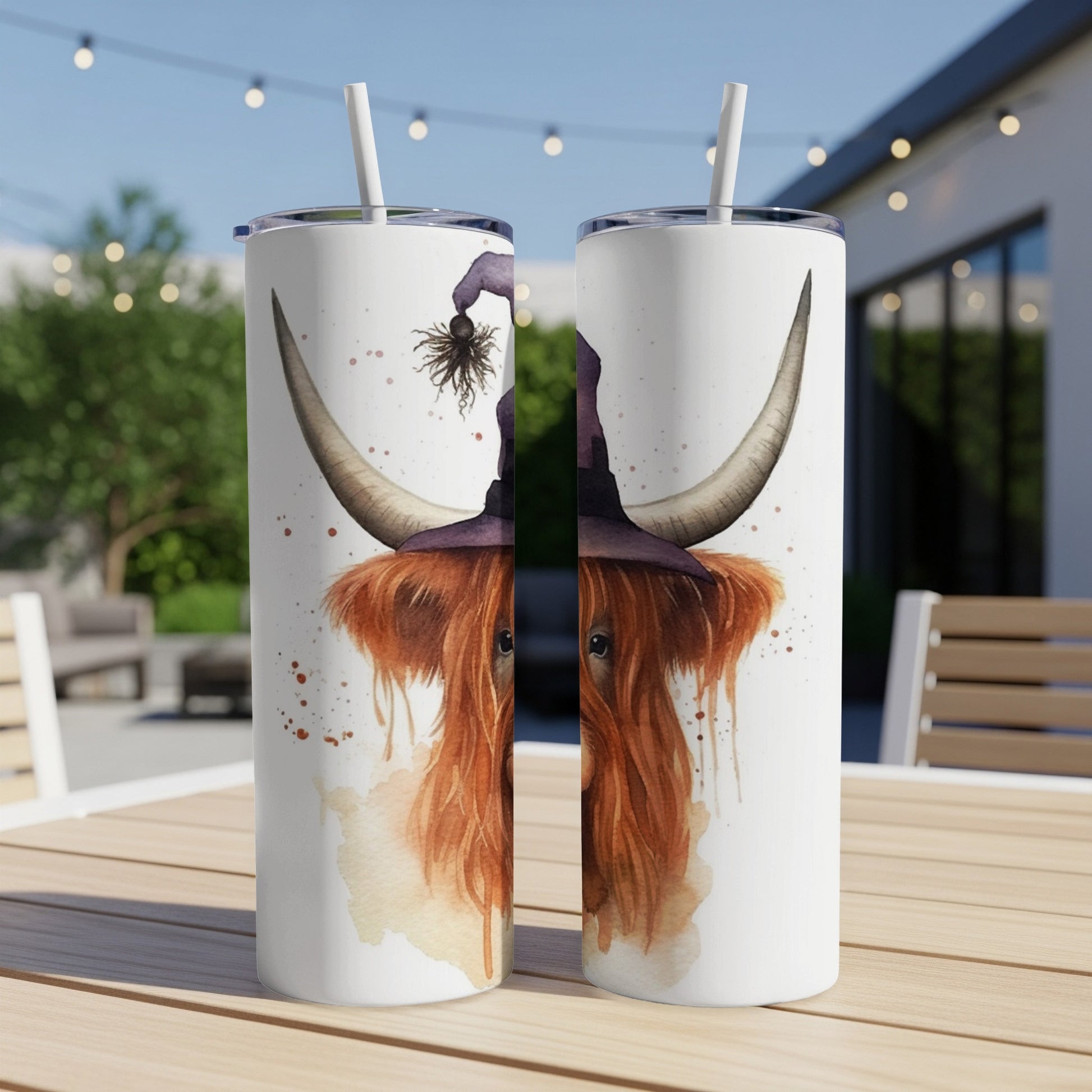Highland cow wearing witch hat on a tumbler.