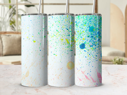 Three tumblers with colorful paint splatter design on white background.