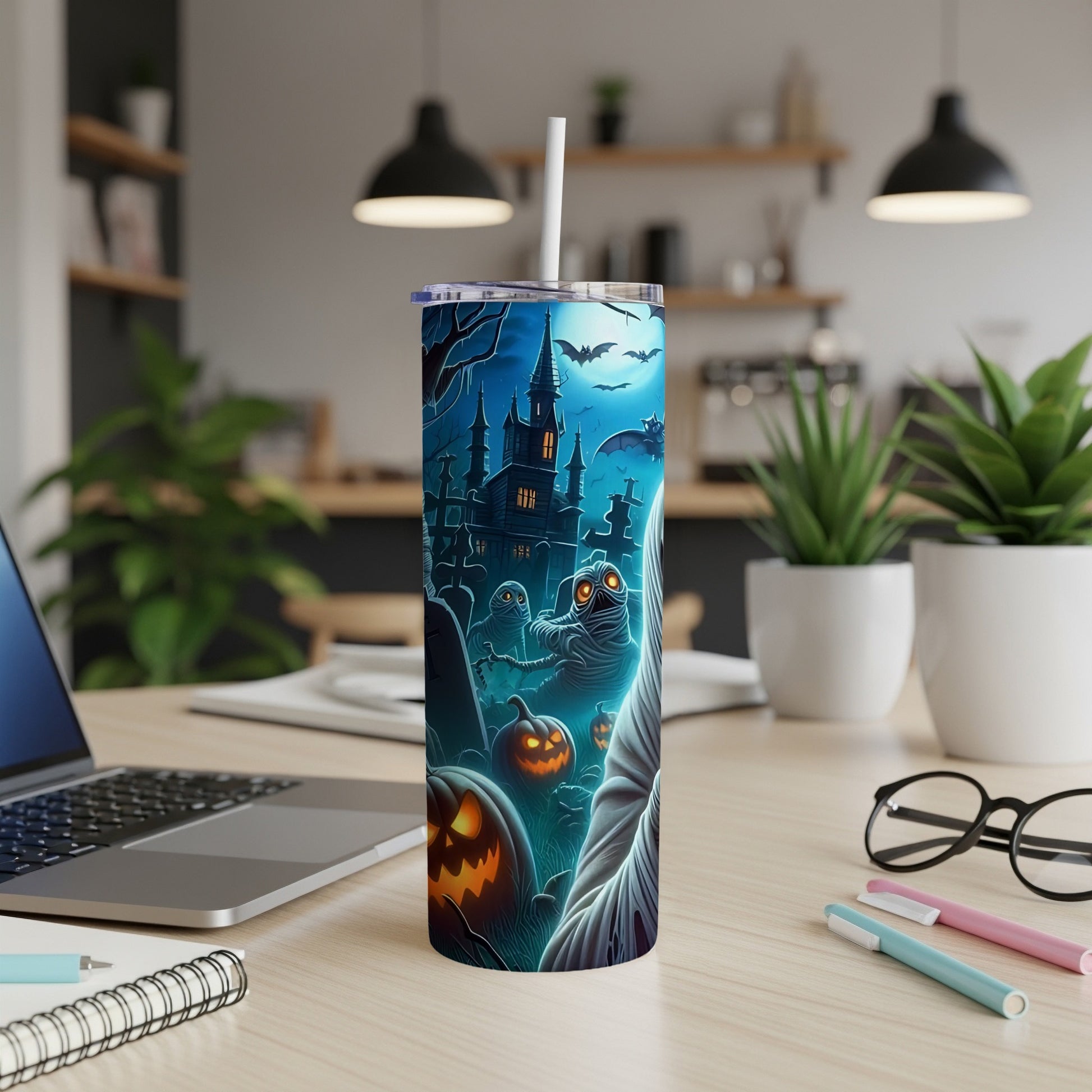 Tumbler with Halloween-themed art featuring mummies, pumpkins, and a haunted castle.