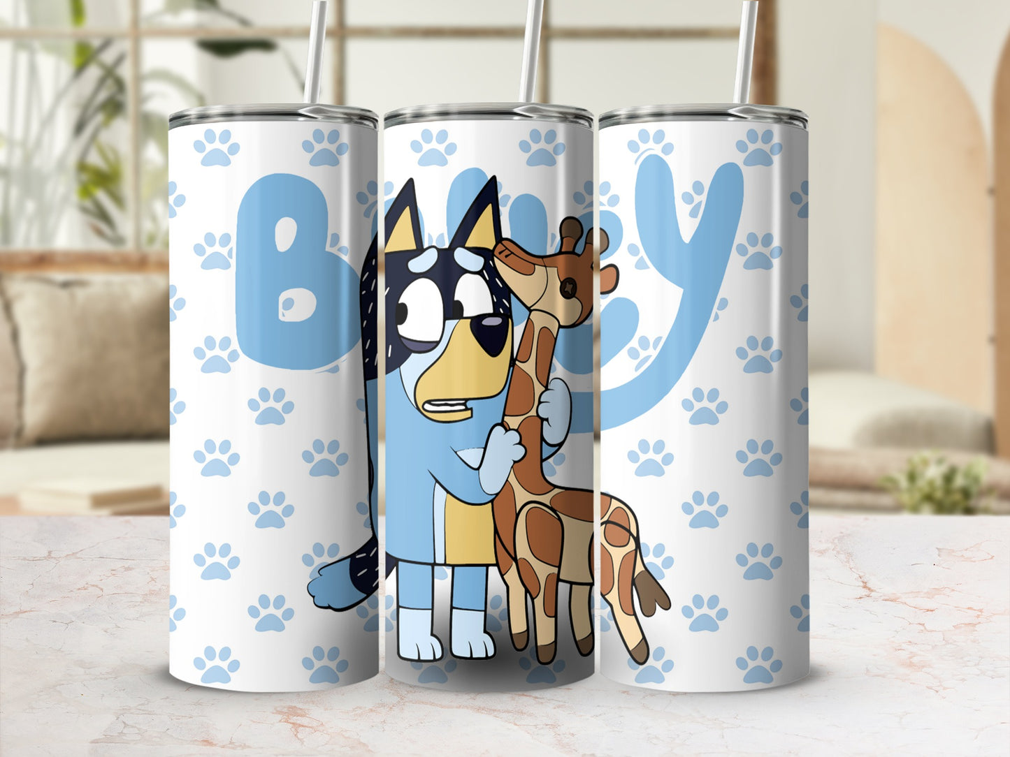 Bluey and Bingo hug a giraffe on a tumbler with paw prints.
