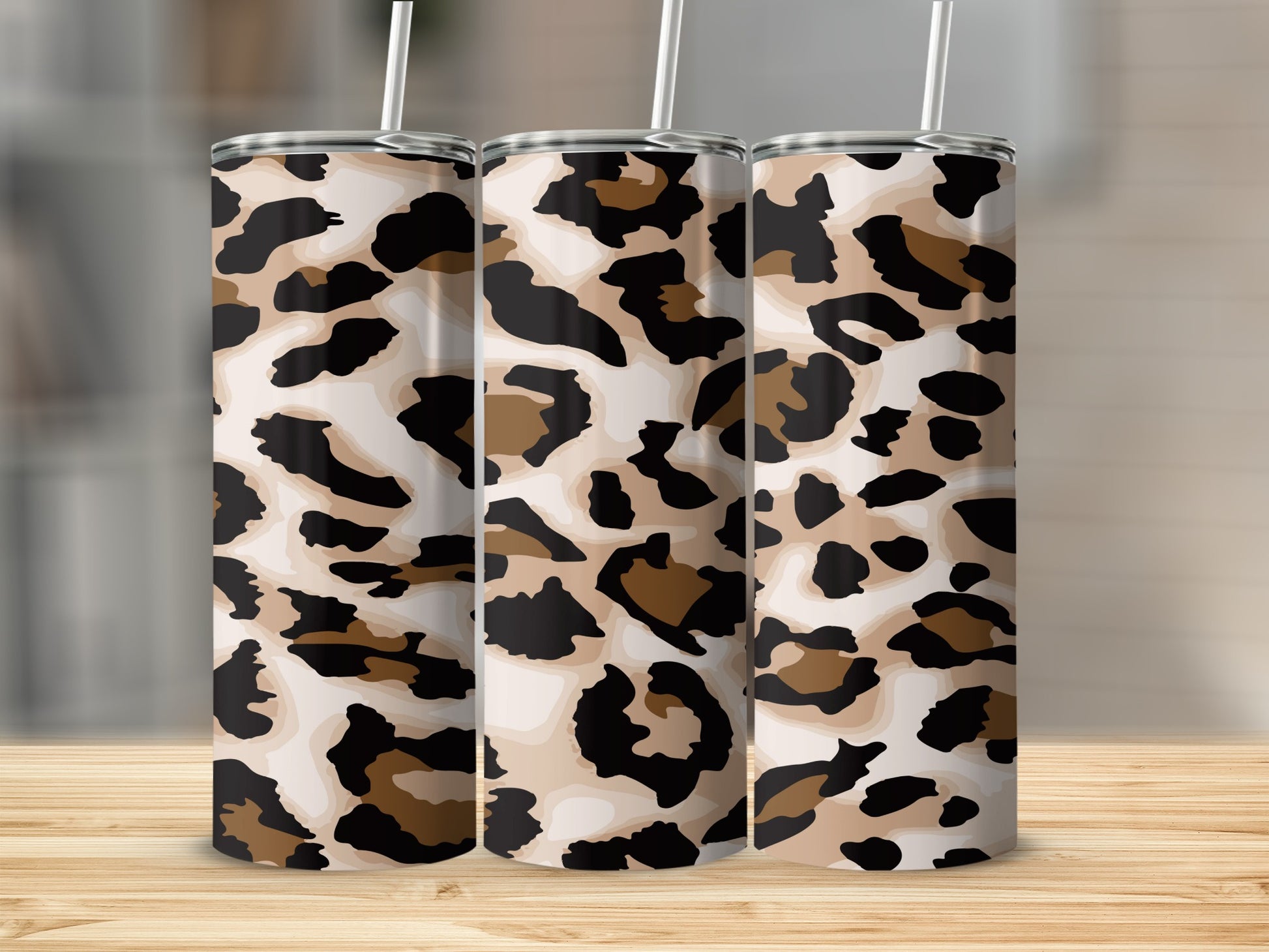 Three tall tumblers with a beige, black, and brown leopard print pattern.