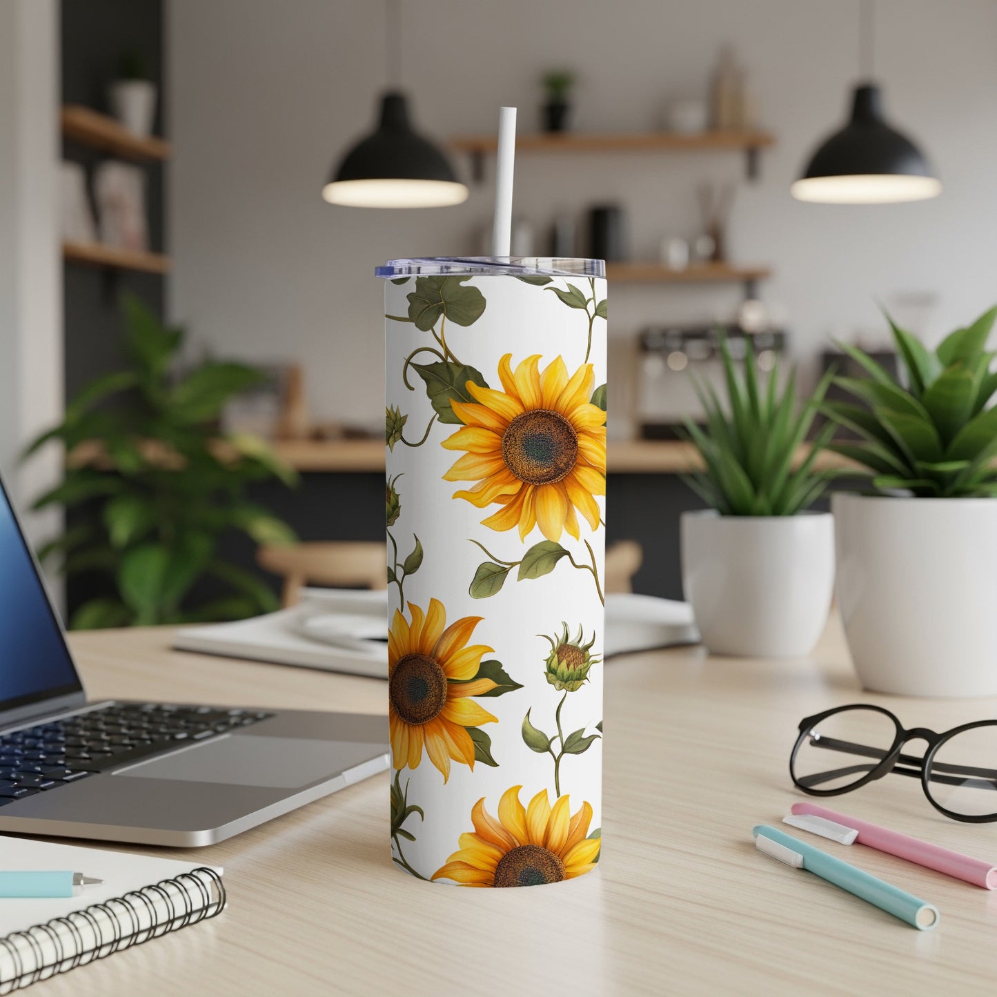 White tumbler with a repeating pattern of sunflowers and green leaves.