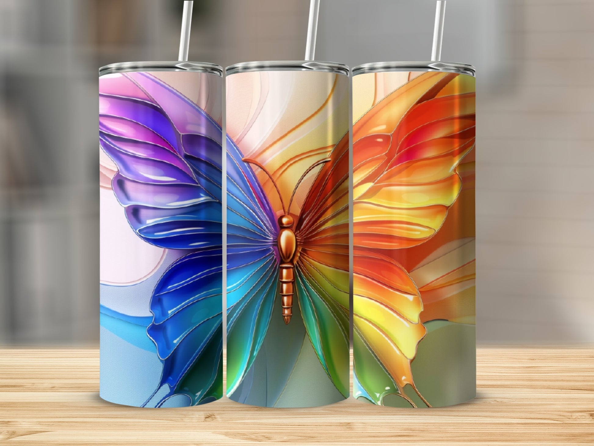 Three tumblers featuring a colorful butterfly wing design.
