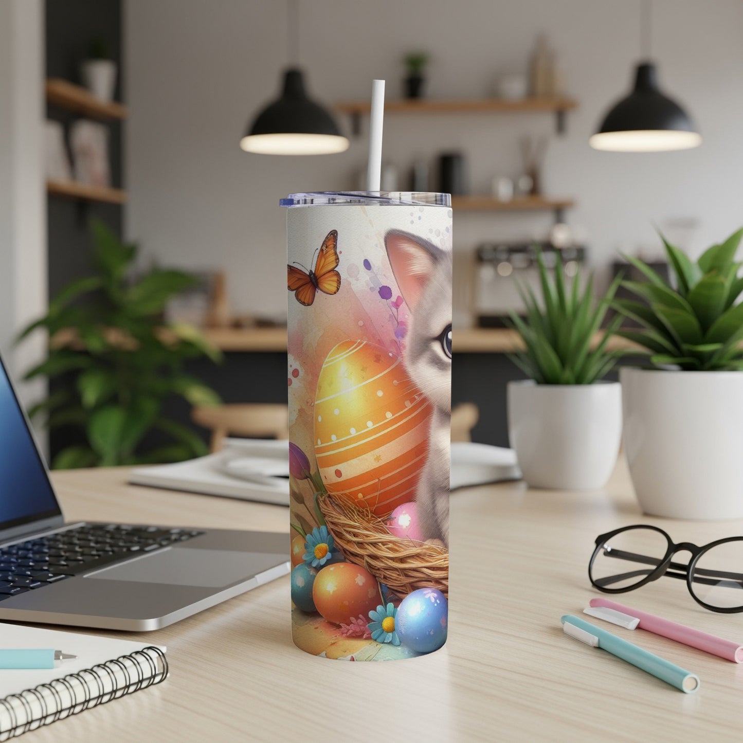 Easter-themed tumbler with a cat and painted eggs in a nest.