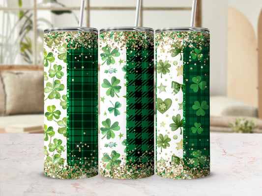 Three green tumblers with shamrocks, plaid patterns, and glitter.
