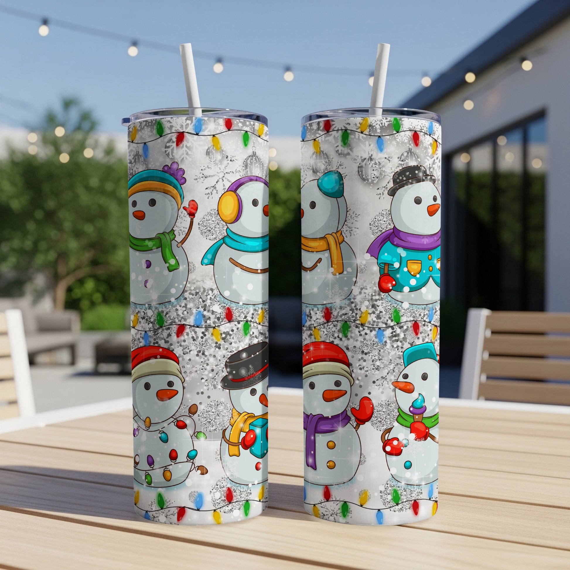 Two tumblers decorated with cartoon snowmen and colorful Christmas lights.
