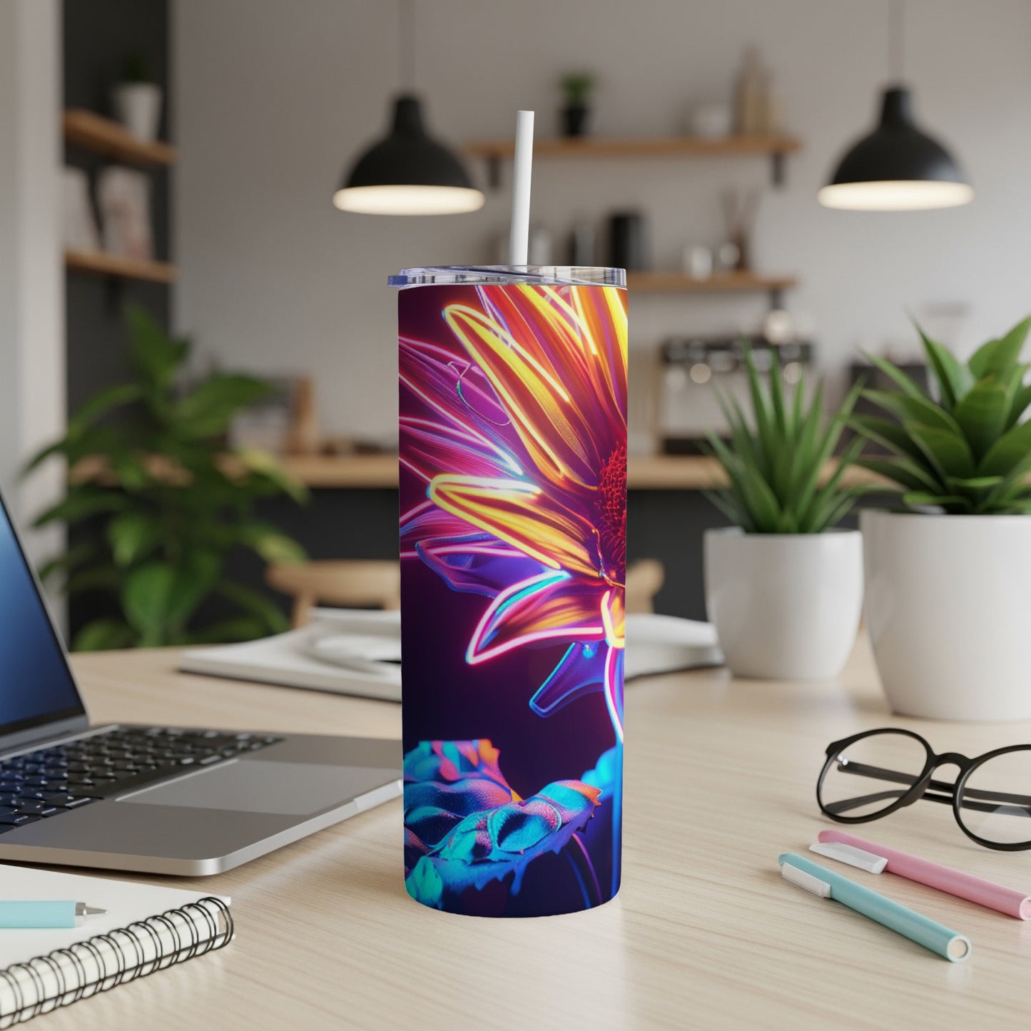 Neon flower design on a dark background, on a stainless steel tumbler.