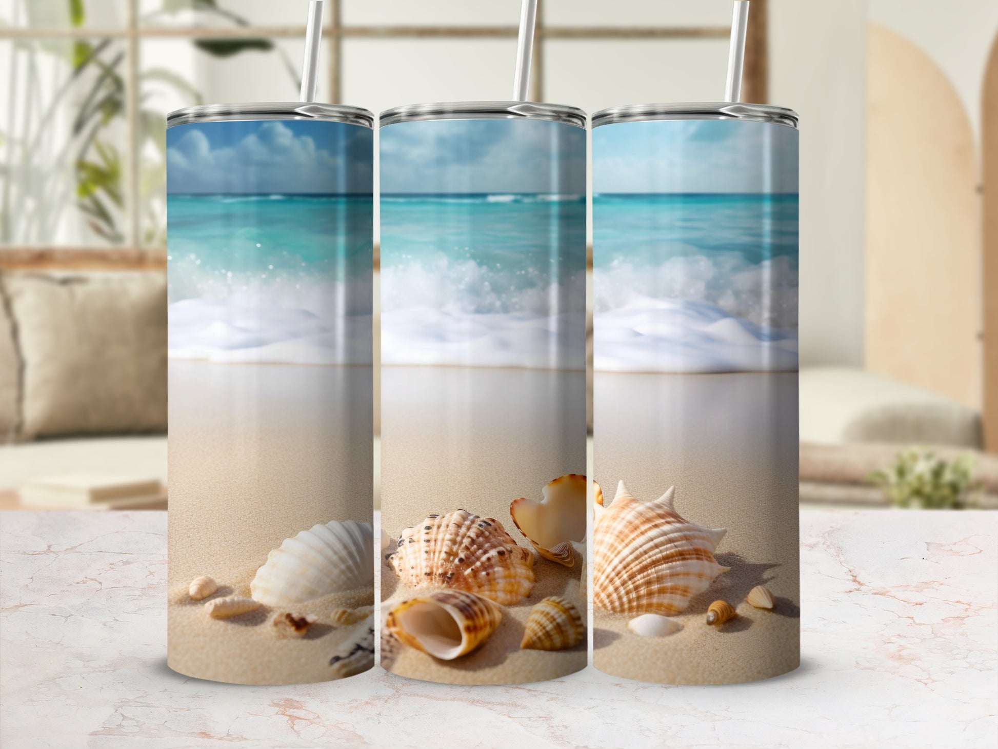 Three tumblers with a beach scene and seashells.