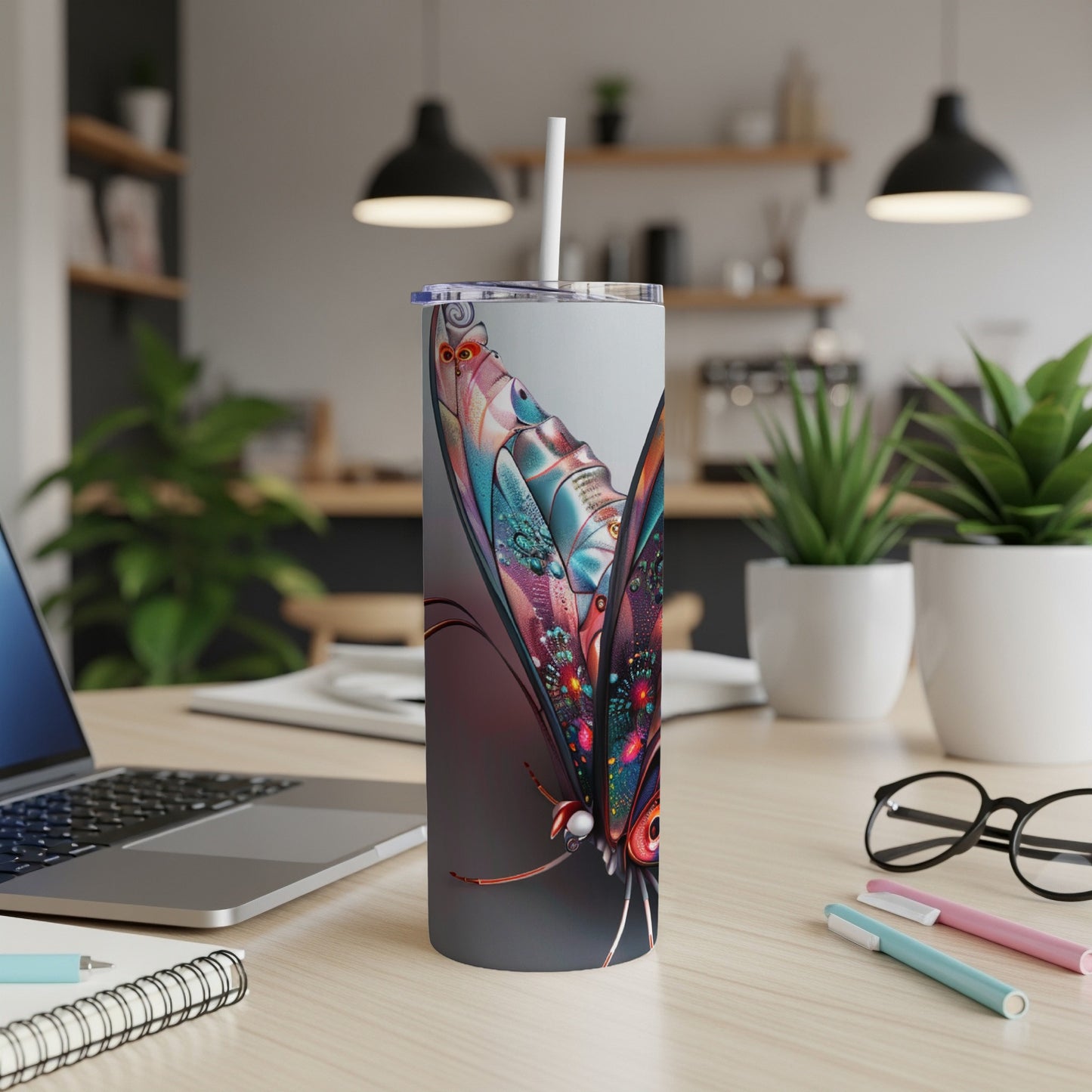 Colorful butterfly illustration on a tall, slim tumbler with a straw.