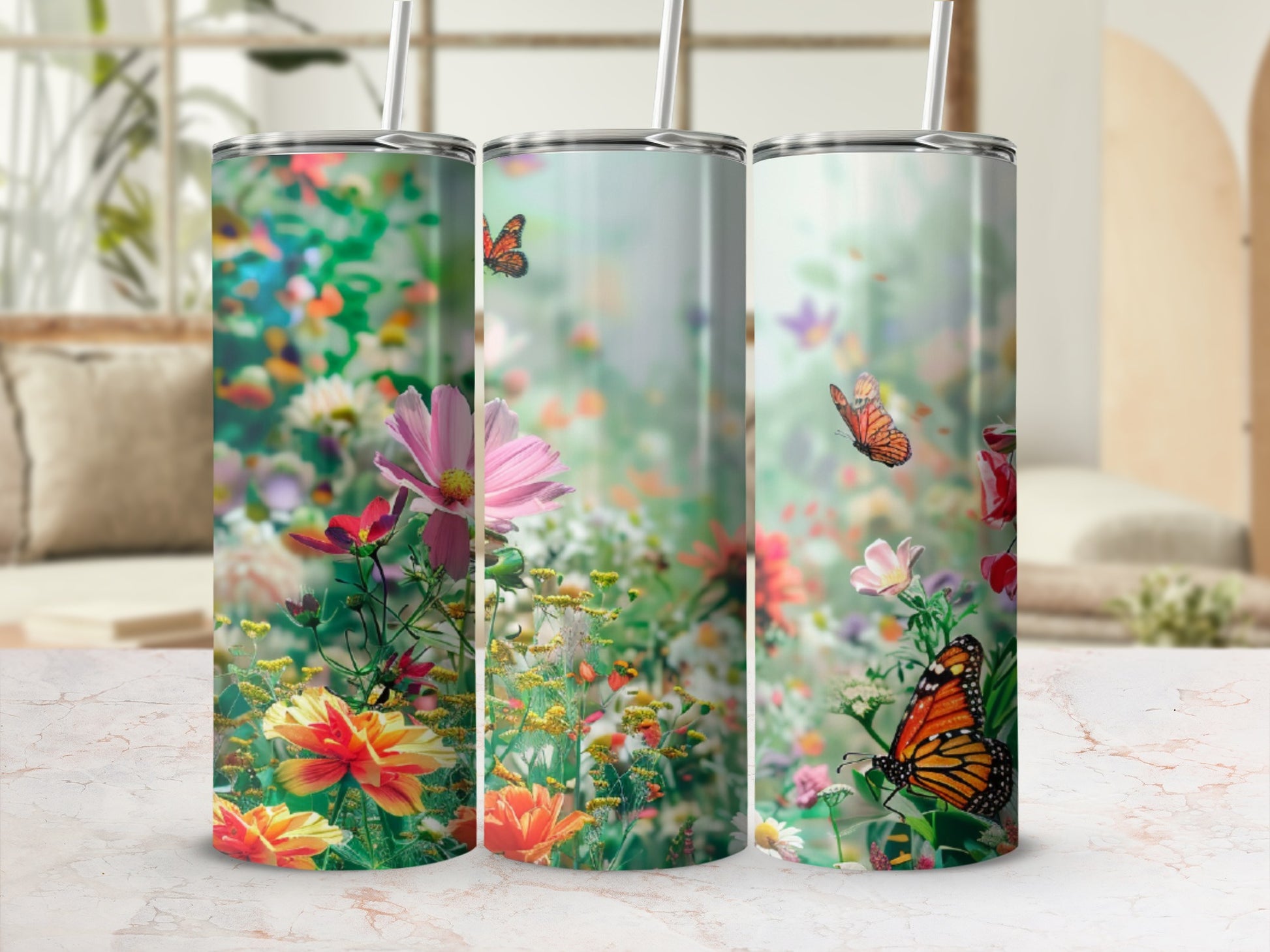 Three tumblers with a floral and butterfly design.