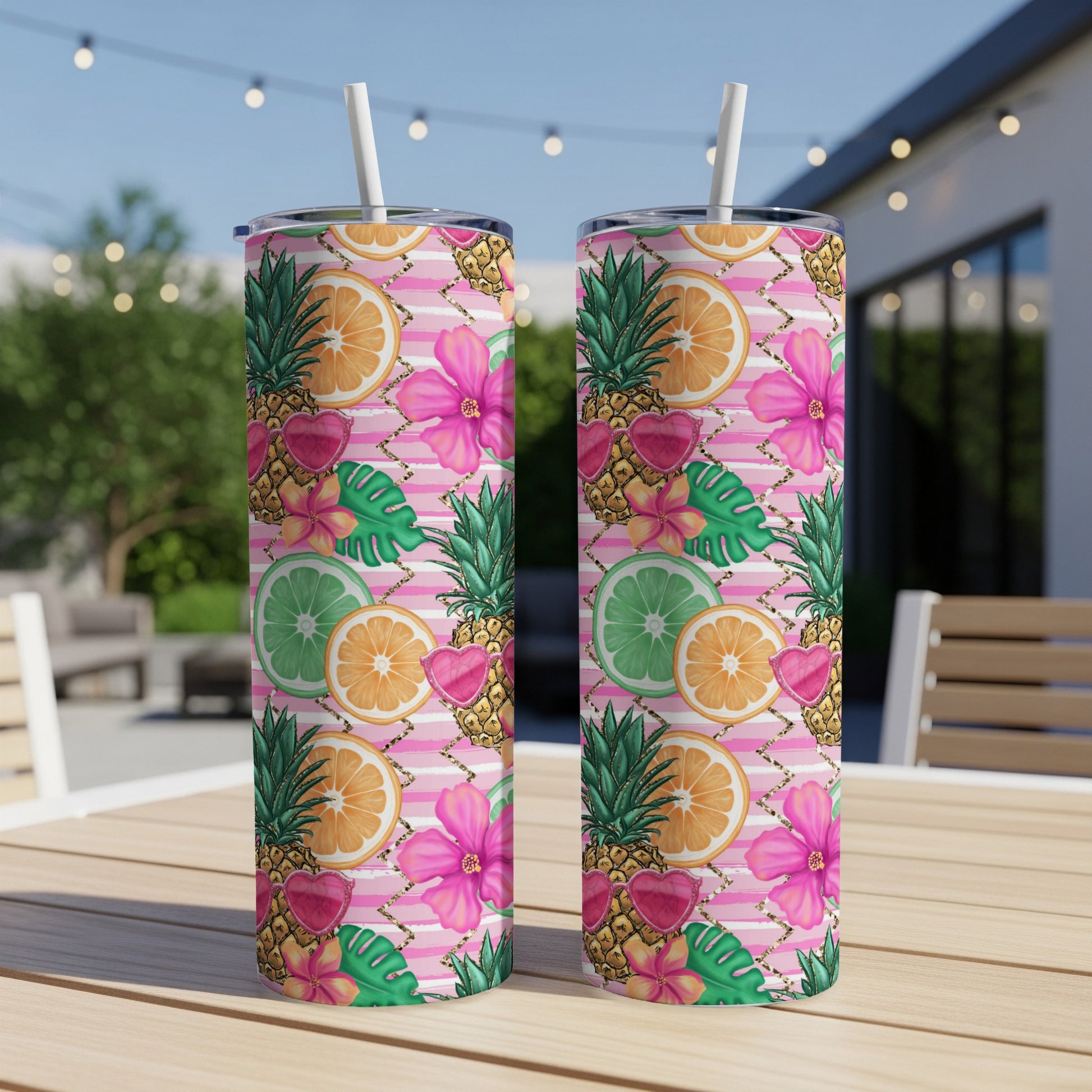 Two tall tumblers with tropical fruit, flower, and heart pattern.