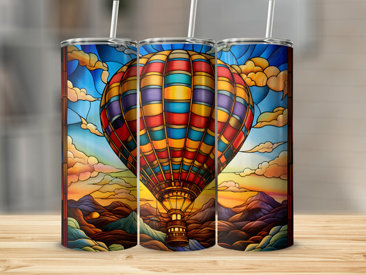 Stained glass hot air balloon over mountains at sunset design on three tumblers.