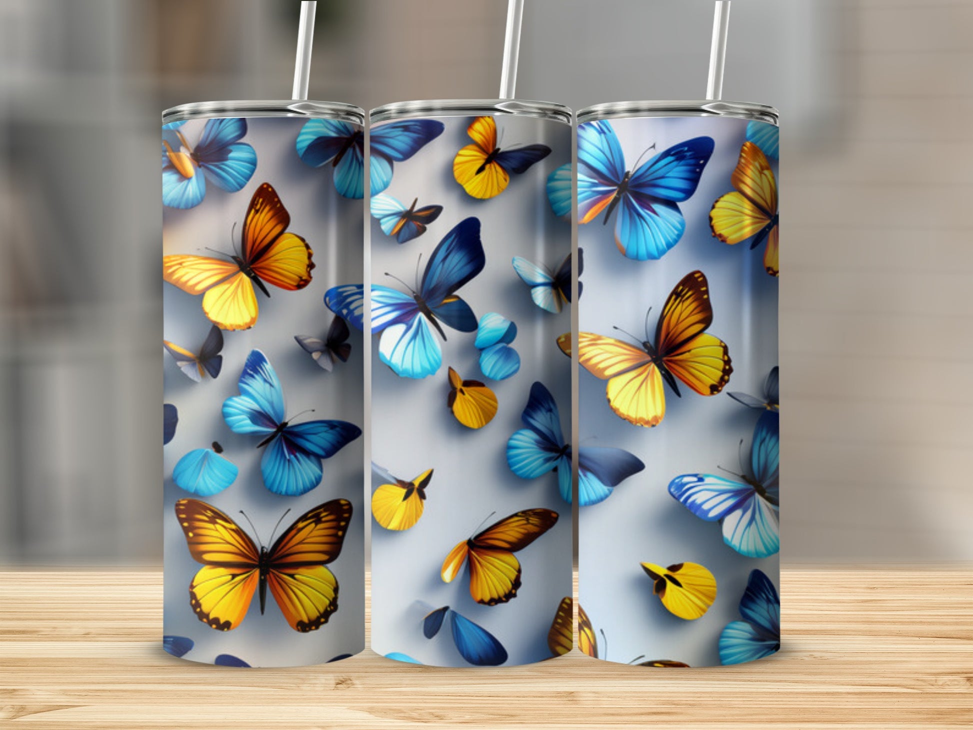 Three tumblers featuring a collage of colorful butterflies in flight.