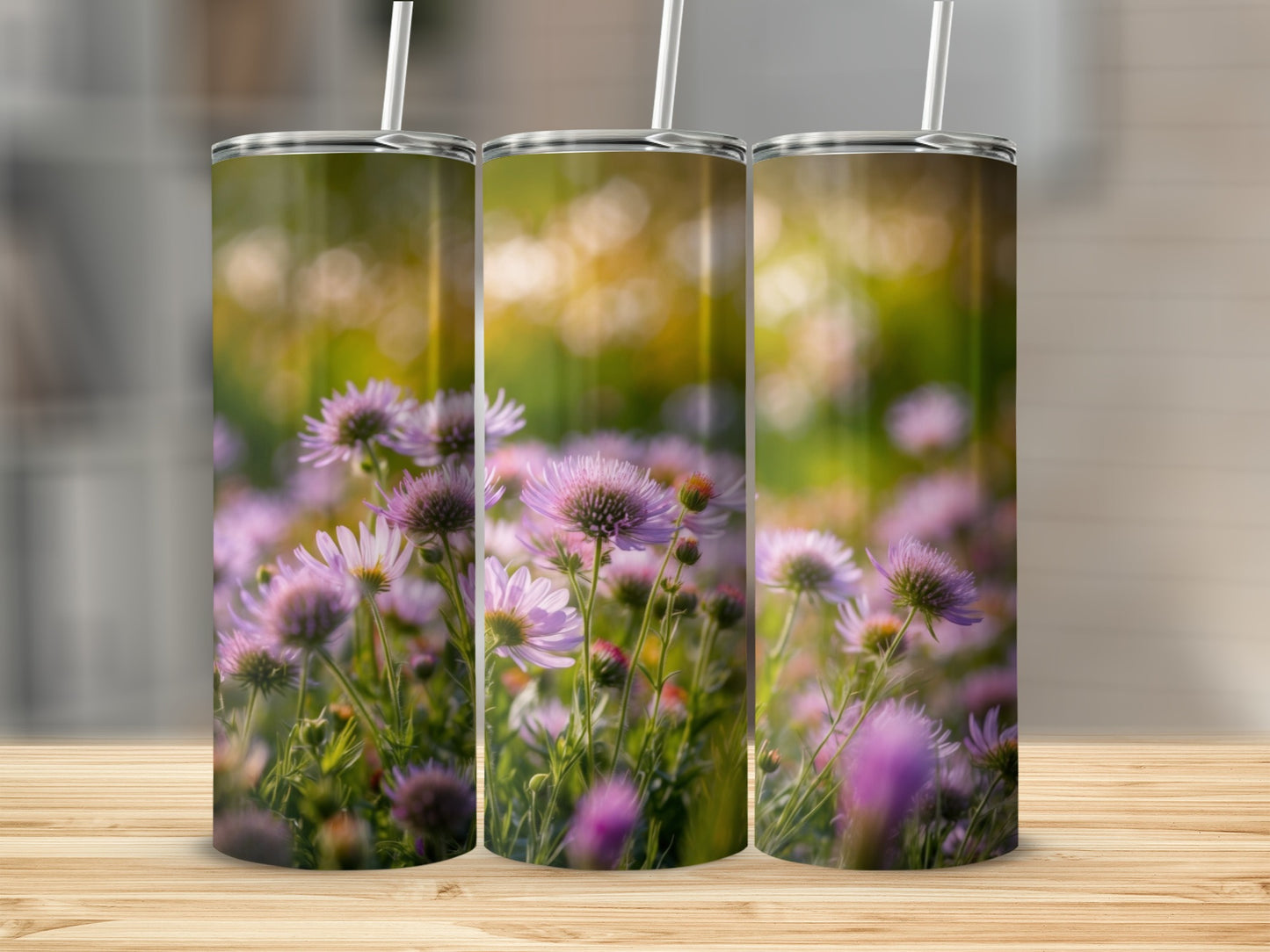 Three tumblers featuring a close-up of pink and purple wildflowers in soft sunlight.