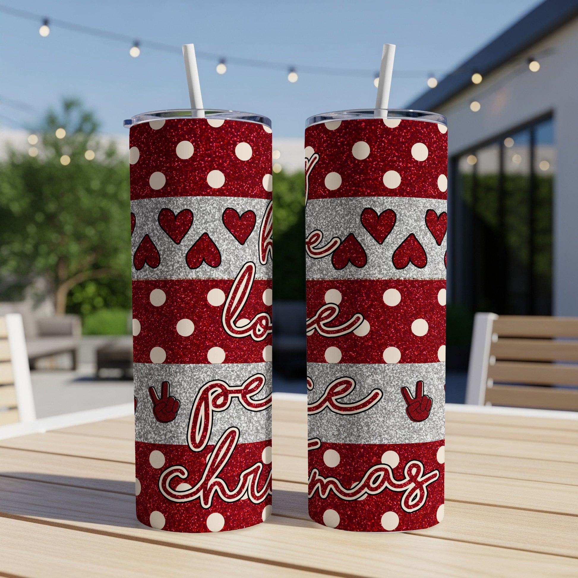 Red glitter tumblers with white hearts, "peace" and "love" text, on a table.