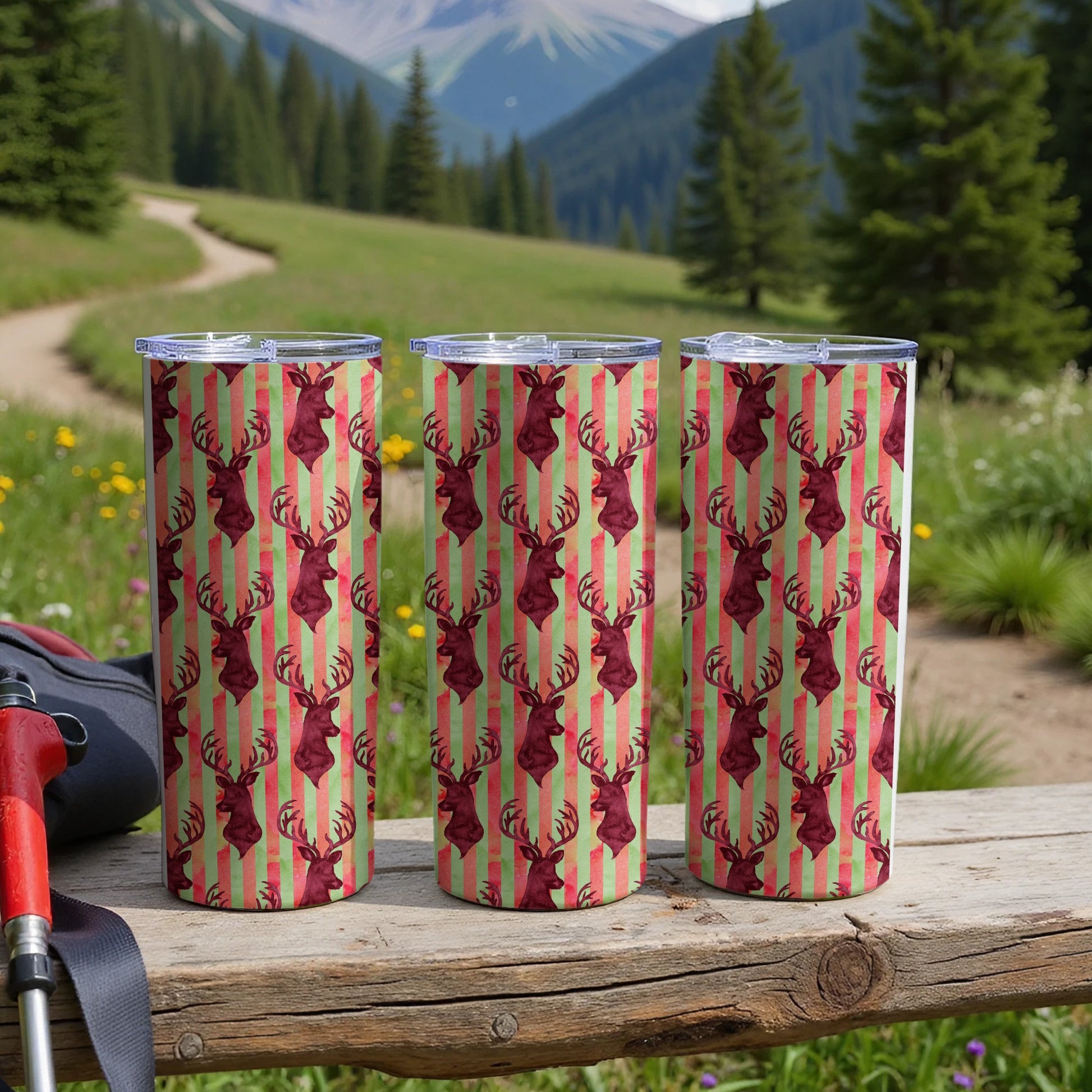 Three tumblers with a red deer pattern on green and red striped background.