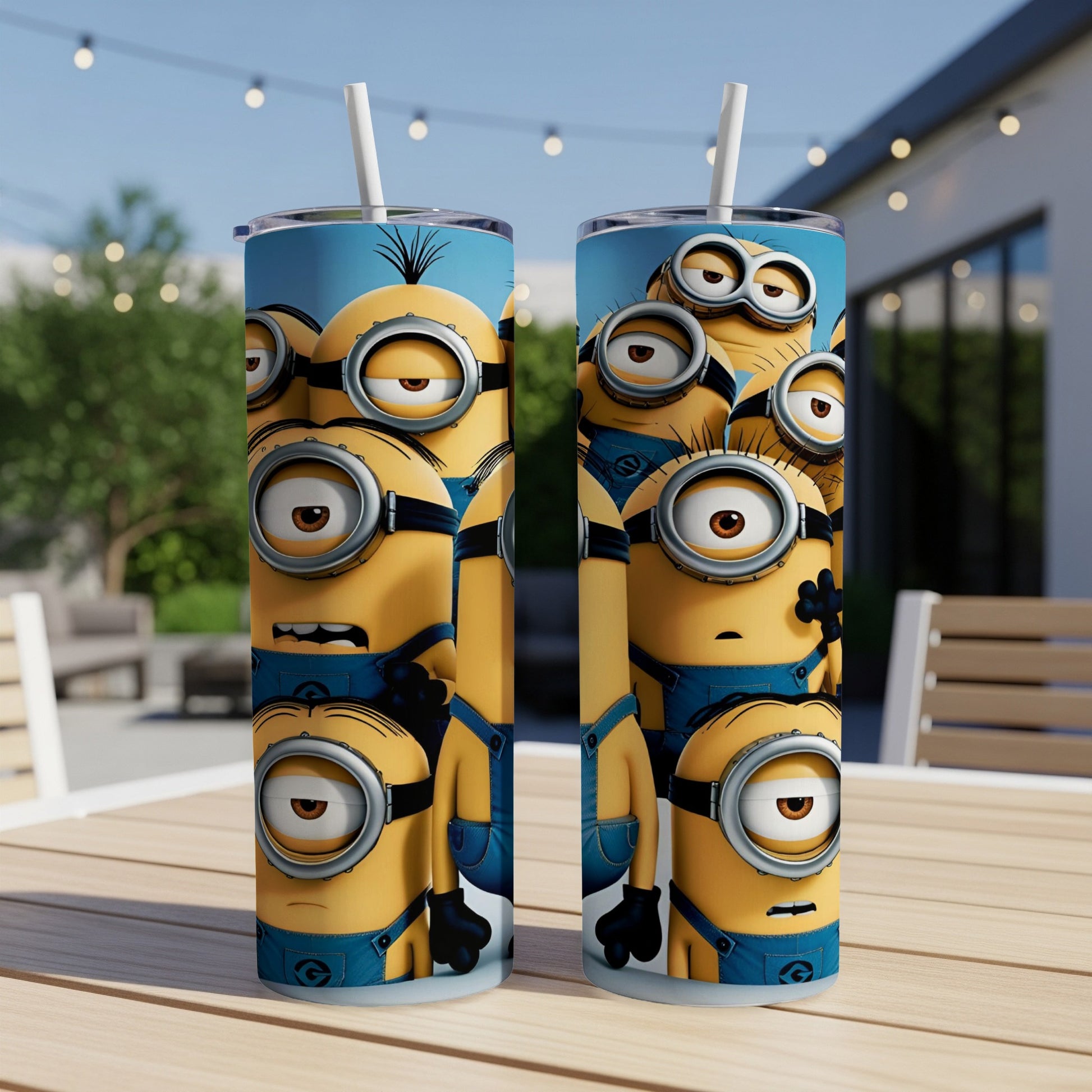 Two Minions tumblers with straws on a wooden table.