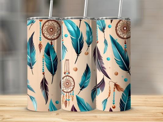 Three tumblers with dreamcatcher and feather designs on a wooden surface.