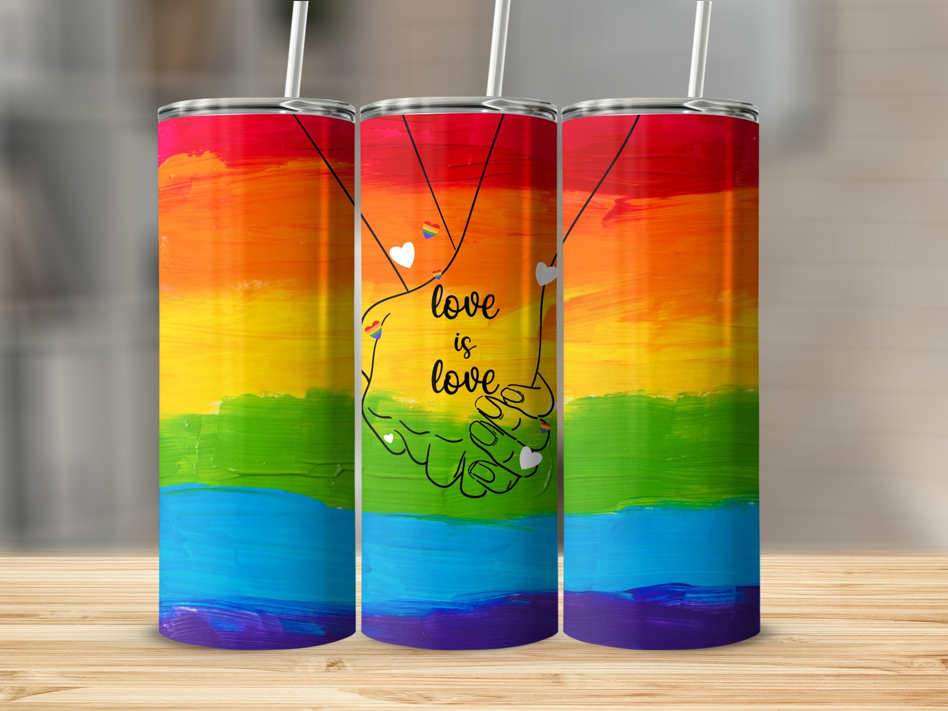 Tumbler with rainbow flag design and hands holding, "love is love" text.