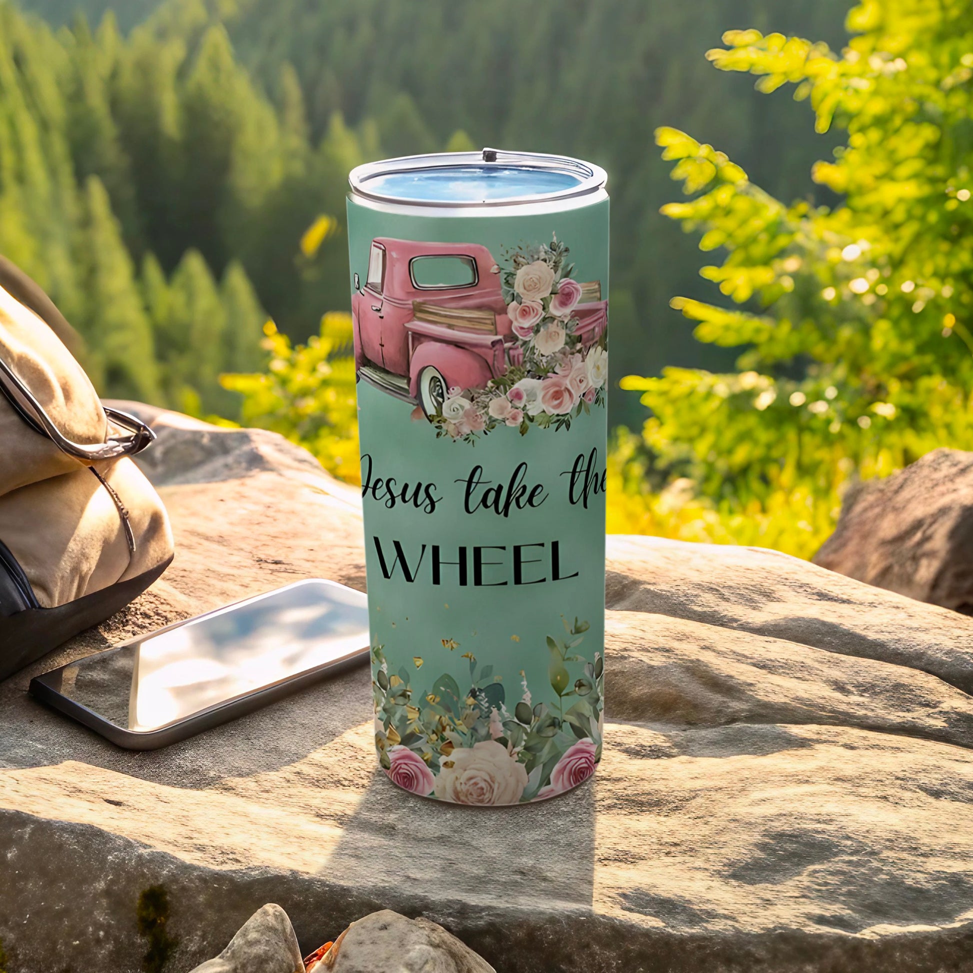 Pink truck with flowers and "Jesus take the wheel" text on a tumbler.