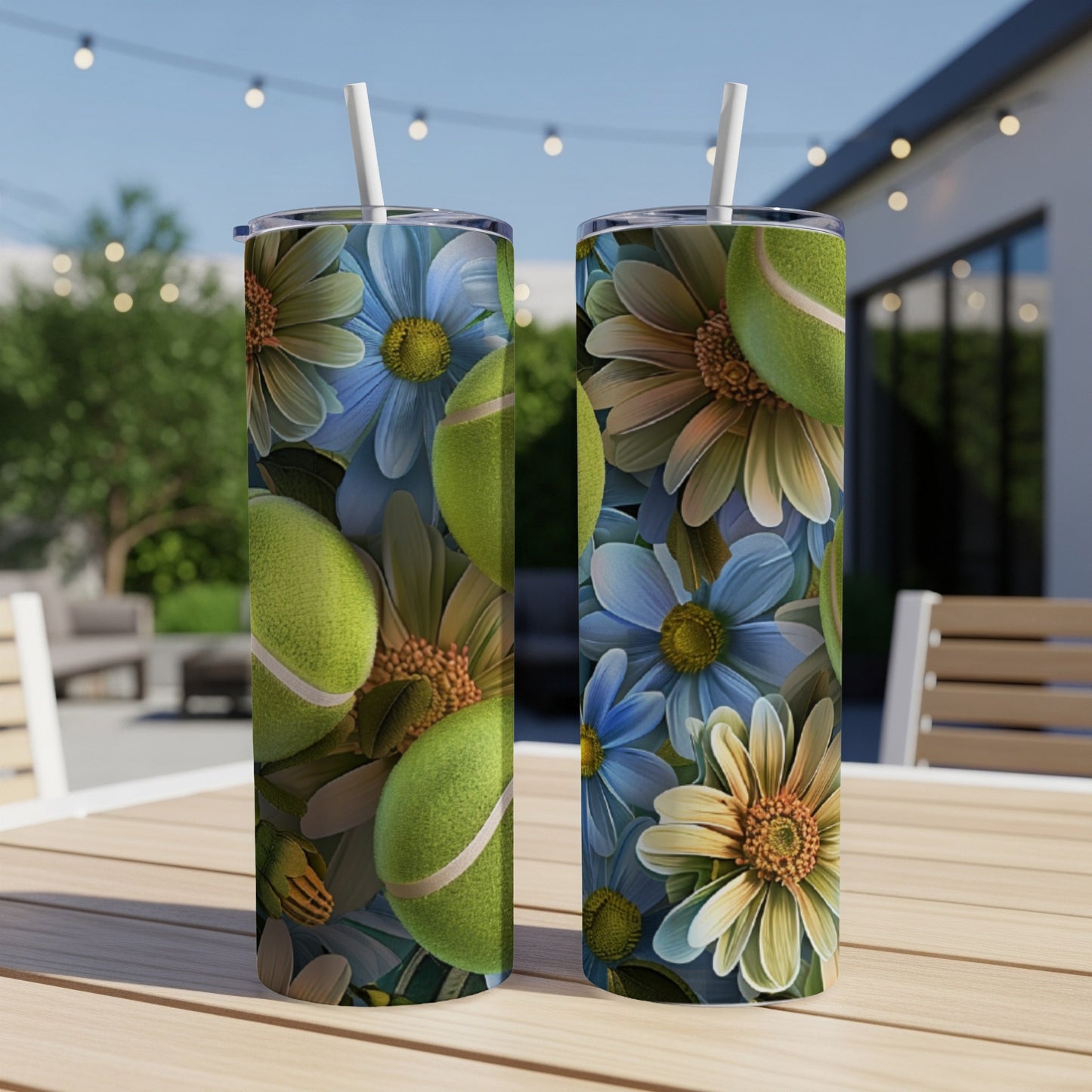 Two tumblers with a floral and tennis ball design, on a table outdoors.