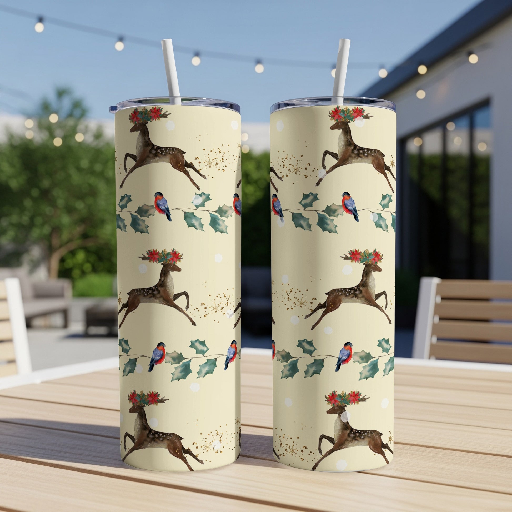 Two tall, slim tumblers with a festive reindeer and cardinal pattern.