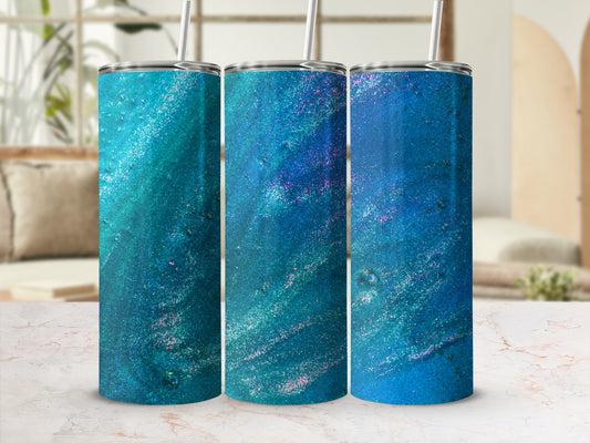 Three glitter tumblers with blue and teal swirling abstract designs.