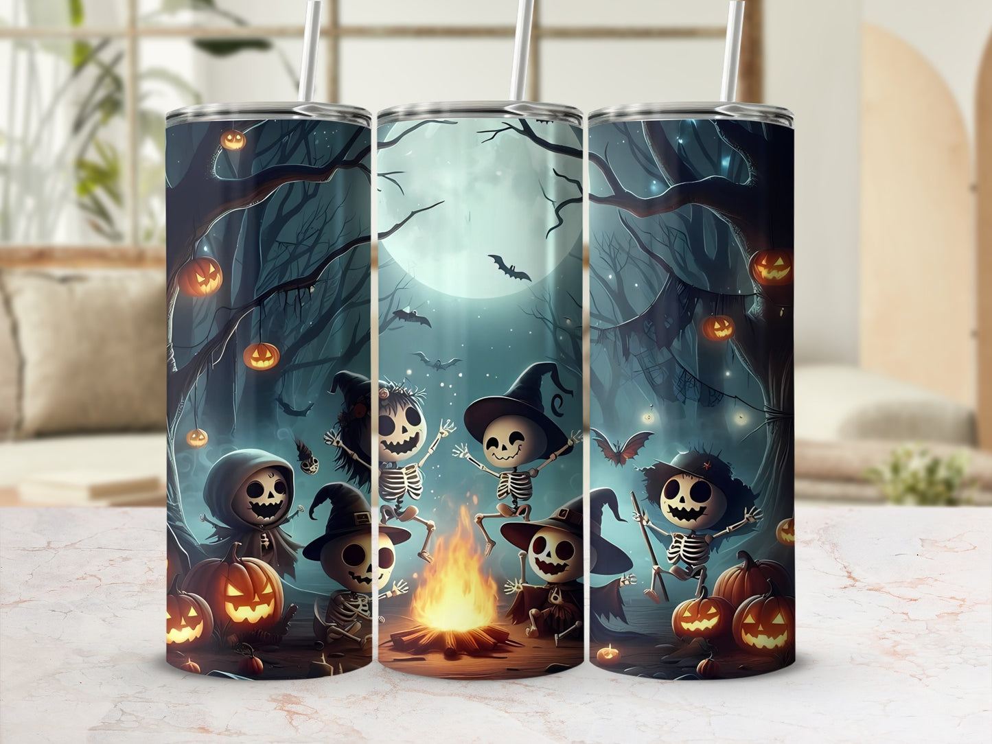 Halloween tumblers with cartoon skeletons dancing around a campfire and pumpkins.