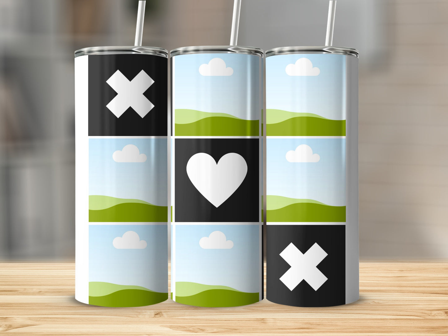Three tumblers with tic-tac-toe grid designs featuring X's, a heart, and landscape graphics.