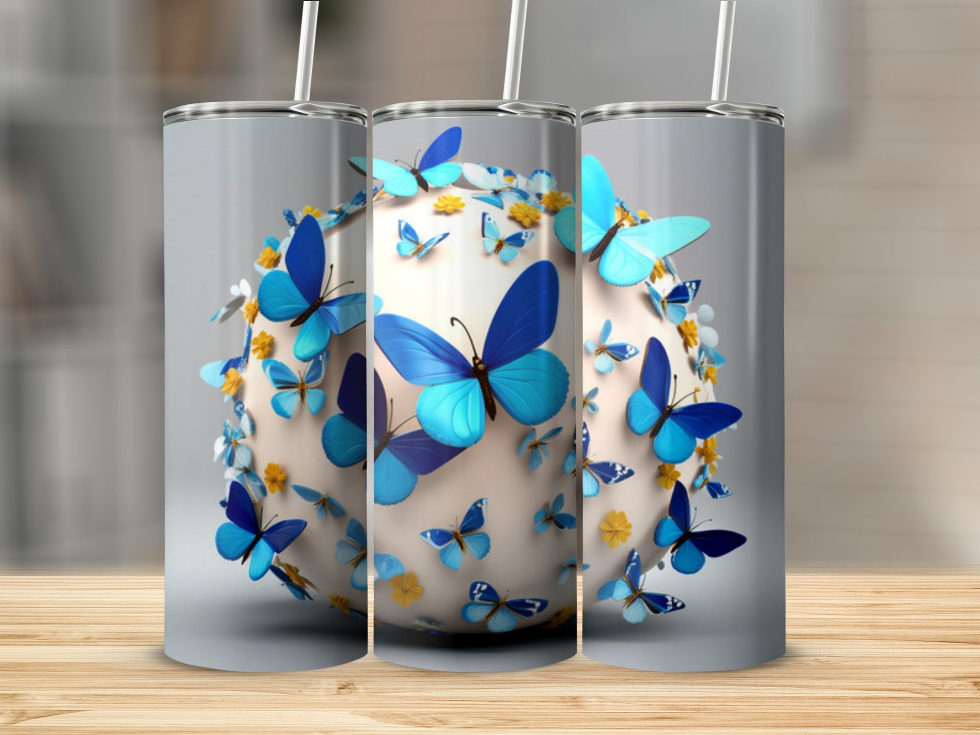 Three tumblers showcasing a blue butterfly orb design.